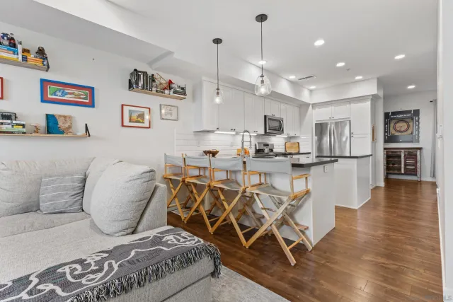 a living room with furniture and kitchen view