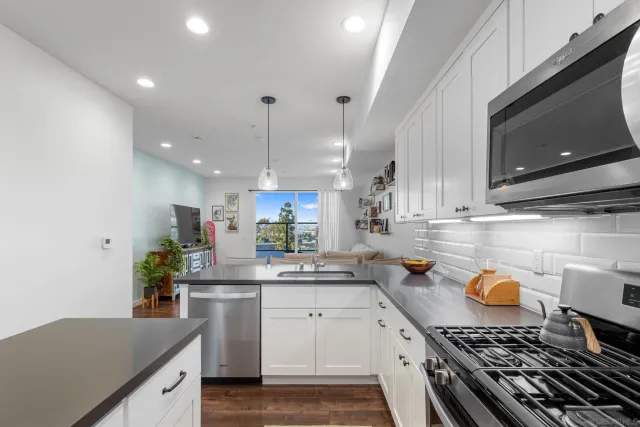 a kitchen with a sink a stove and cabinets