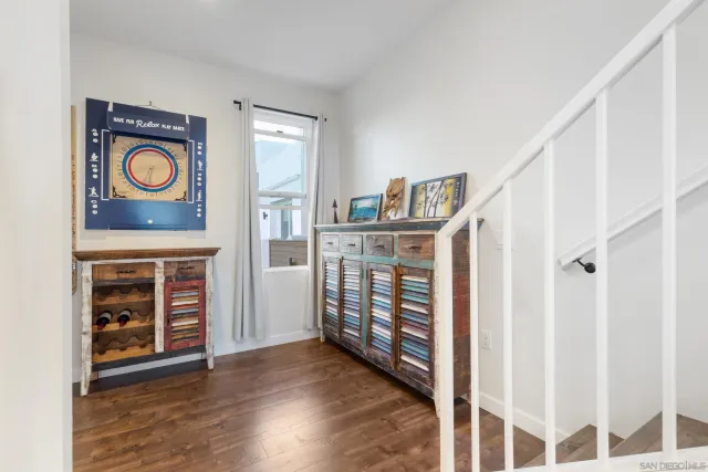a view of a hallway with wooden floor and entryway