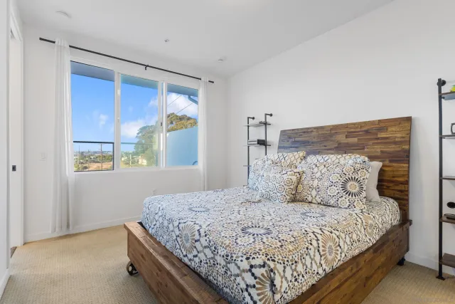 a bedroom with a large bed and a window