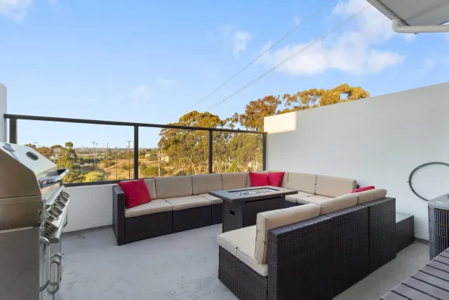 a living room with furniture and a floor to ceiling window