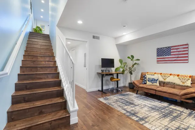 a living room with furniture and a stairs
