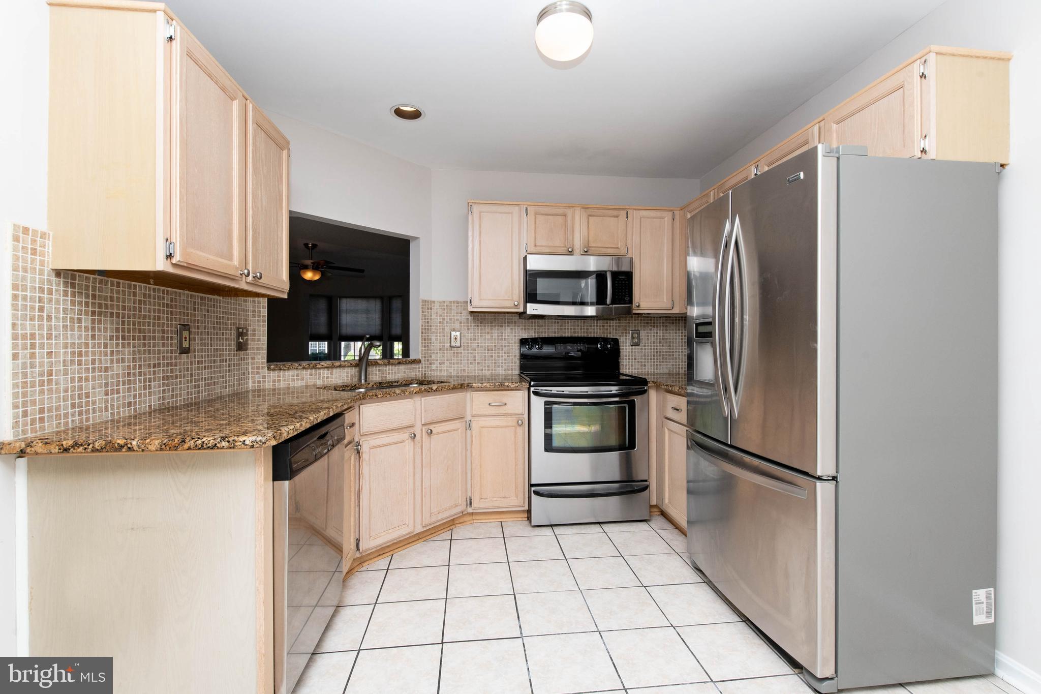 4403 Cole Farm Road Baltimore, MD 21236 - Photo 10 of 30 a kitchen with a refrigerator sink and microwave