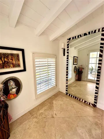 a view of a room with furniture and lots of windows