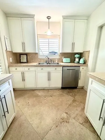 a kitchen with sink cabinets and window