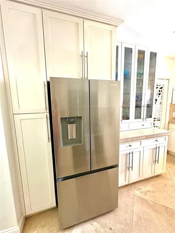 a white refrigerator freezer sitting in a kitchen