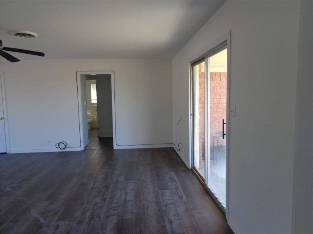 612 South Files Street Itasca, TX 76055 - Photo 29 of 30 Spare room with dark wood finished floors and ceiling fan