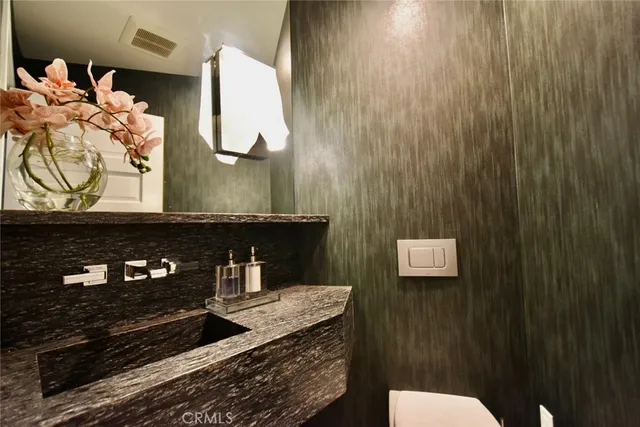 a spacious bedroom with a bed and a chandelier