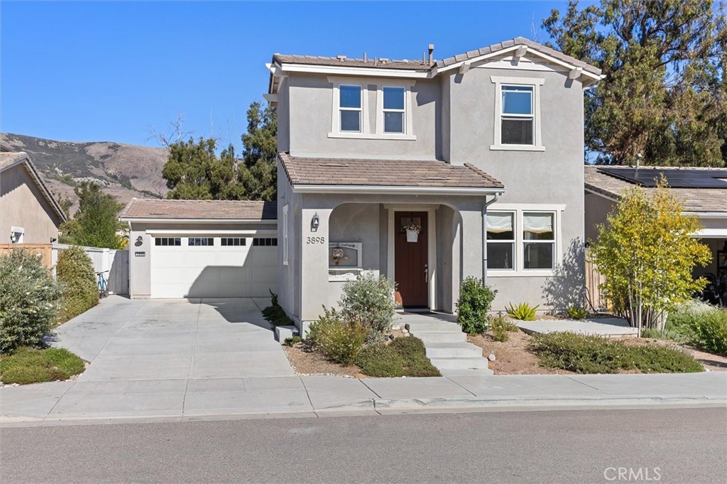 3898 Hayfield Loop San Luis Obispo, CA 93401 - Photo 1 of 19 a front view of a house with a yard and garage