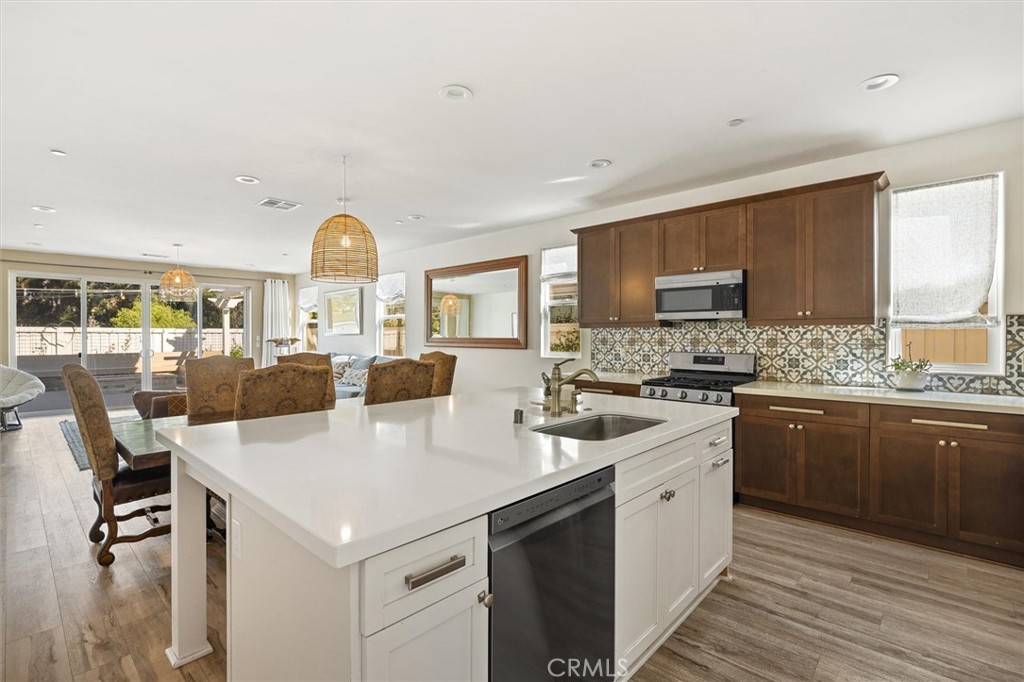 3898 Hayfield Loop San Luis Obispo, CA 93401 - Photo 3 of 19 a kitchen with a sink a stove cabinets and wooden floor
