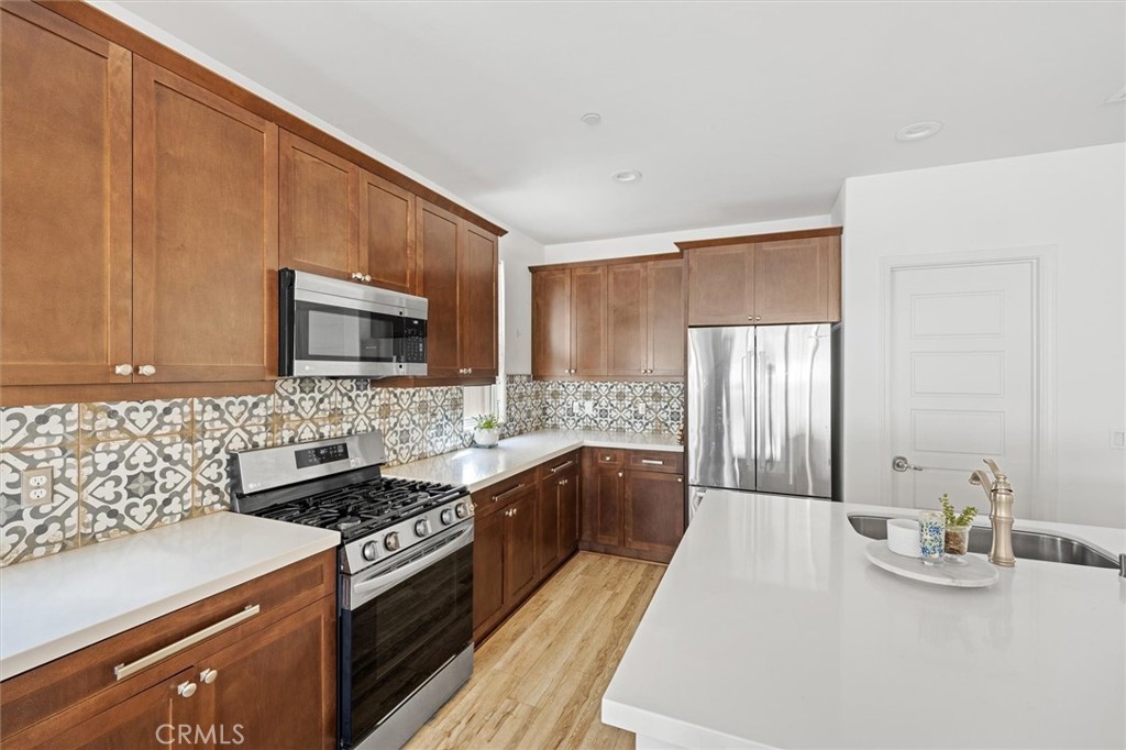 3898 Hayfield Loop San Luis Obispo, CA 93401 - Photo 4 of 19 a kitchen with stainless steel appliances a sink a stove and a microwave