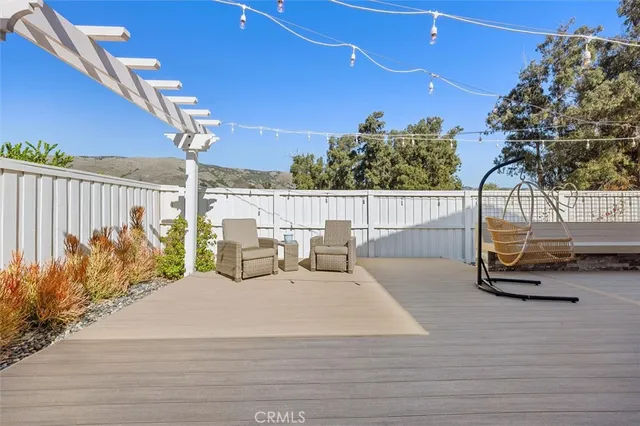 a view of a patio with couches table and chairs and potted plants