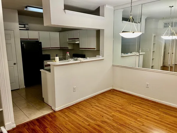 a kitchen with a refrigerator stove and cabinets