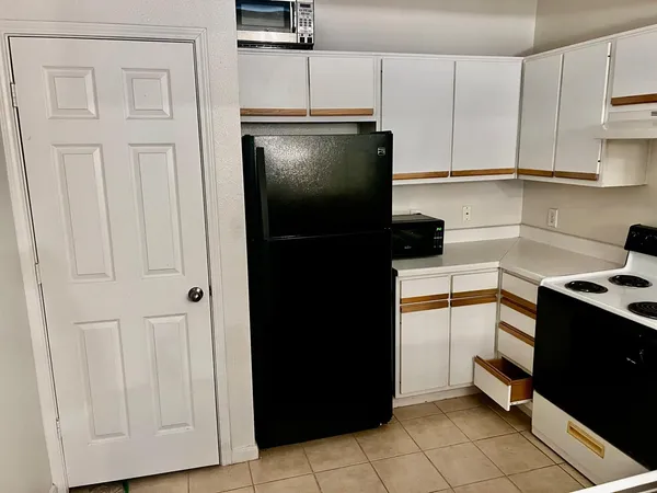 a kitchen with stainless steel appliances granite countertop a refrigerator and a stove