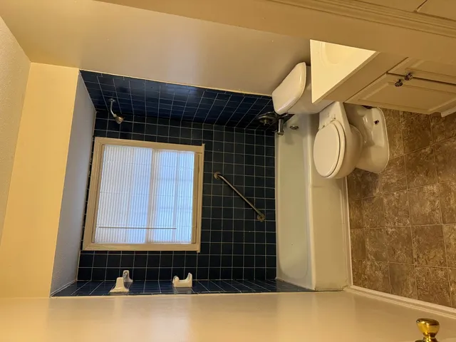 a bathroom with a bathtub and shower