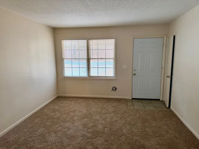 an empty room with a empty space and windows
