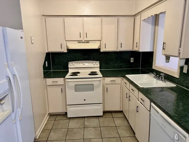 a kitchen with a stove a sink and a refrigerator