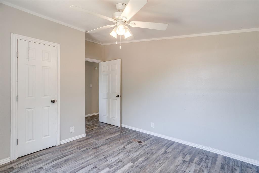 178 Valley Lake Lane Springtown, TX 76082 - Photo 27 of 33 Interior room featuring wood-finish flooring, light-toned walls, white trim, and a ceiling fan with integrated lighting