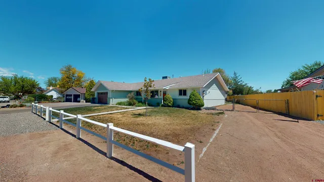 a view of a house with backyard porch and sitting area