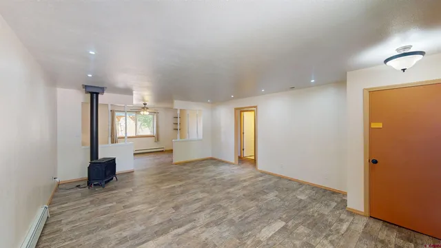 an empty room with windows and closet