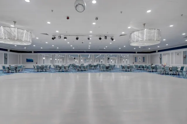 a view of a room with stainless steel appliances lots of white furniture