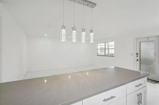 a view of an empty room with chandelier