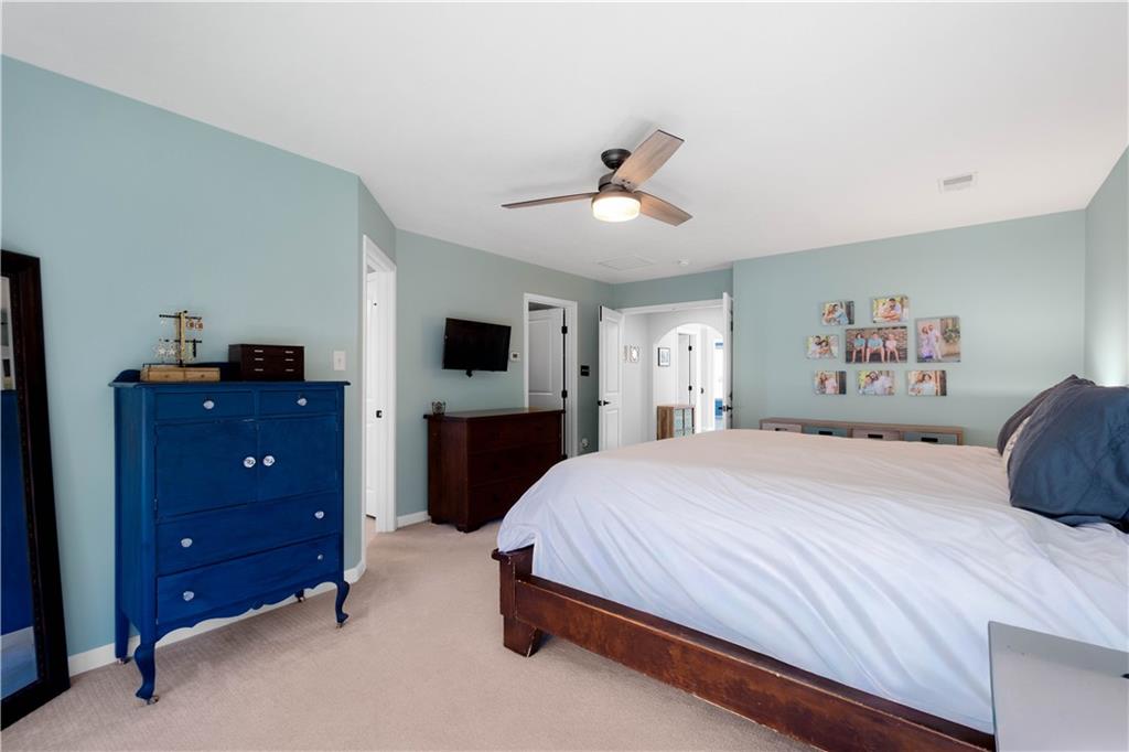 4528 Walnut Ridge Circle McDonald, PA 15057 - Photo 23 of 50 a bedroom with a bed and a flat tv screen on dresser