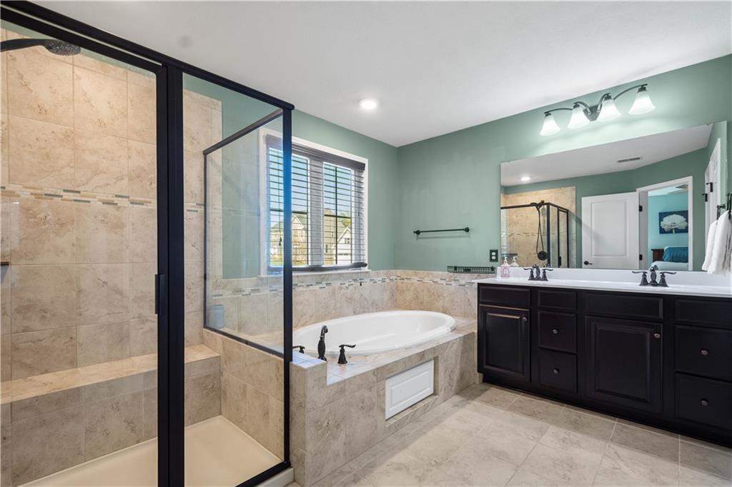 4528 Walnut Ridge Circle McDonald, PA 15057 - Photo 24 of 50 a spacious bathroom with a tub sink shower and mirror