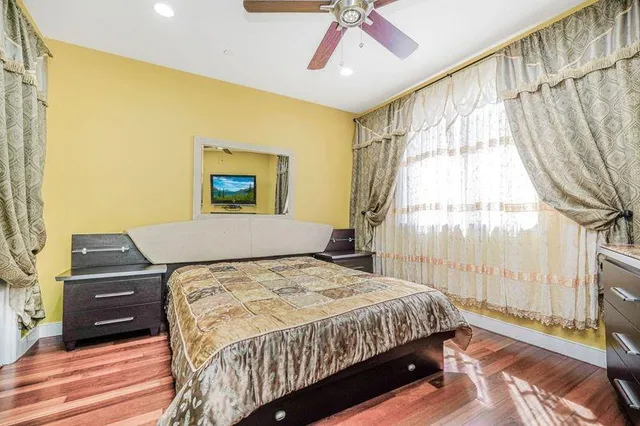 a bedroom with a bed and a window