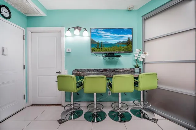 a kitchen with a table chairs refrigerator and microwave