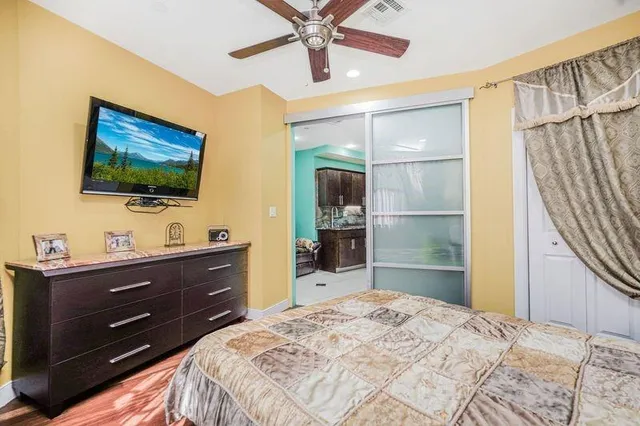 a bedroom with a bed and a flat screen tv