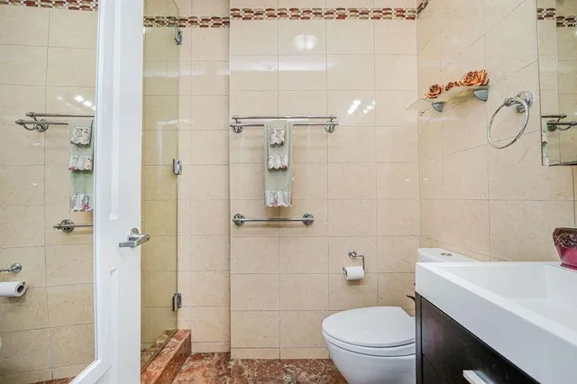 a bathroom with a sink toilet and shower