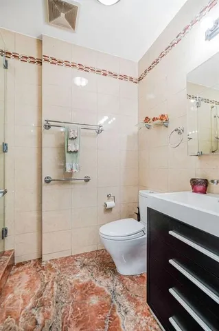 a view of walk in closet with clothes