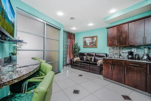 a kitchen with a refrigerator a sink dishwasher a stove and a refrigerator with wooden cabinets