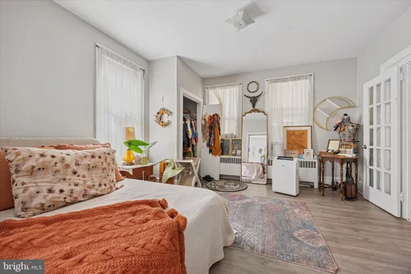 a bedroom with furniture and a window