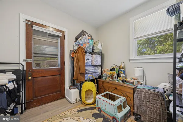 a view of room with hardwood flooring and ceiling fan