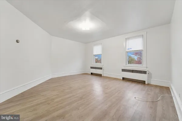 a view of room with wooden floor and window