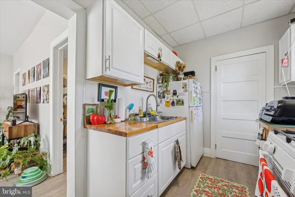 a utility room with stainless steel appliances a stove and a refrigerator