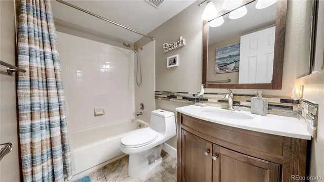 a bathroom with a sink toilet vanity and shower
