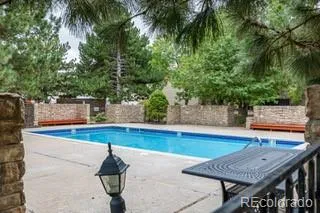 a view of a swimming pool with an outdoor seating