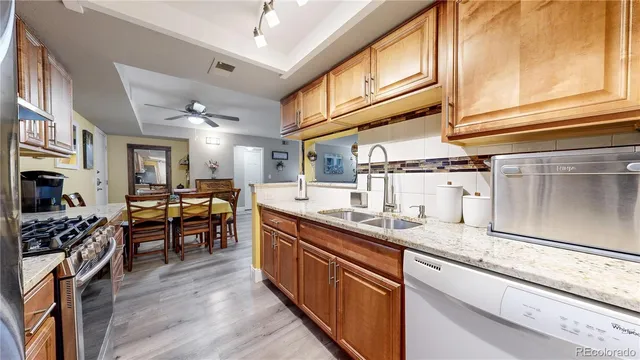 a kitchen with granite countertop lots of counter top space and stainless steel appliances