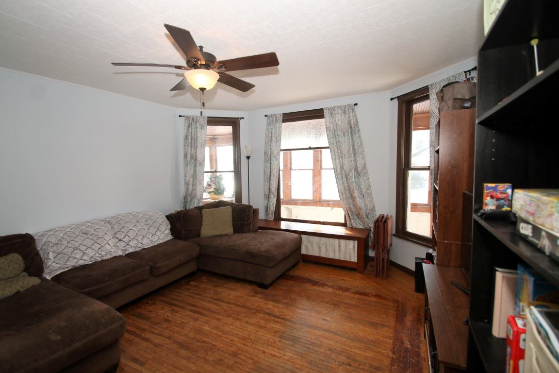 145 4th Street Capron, IL 61012 - Photo 11 of 24 a living room with furniture and a flat screen tv