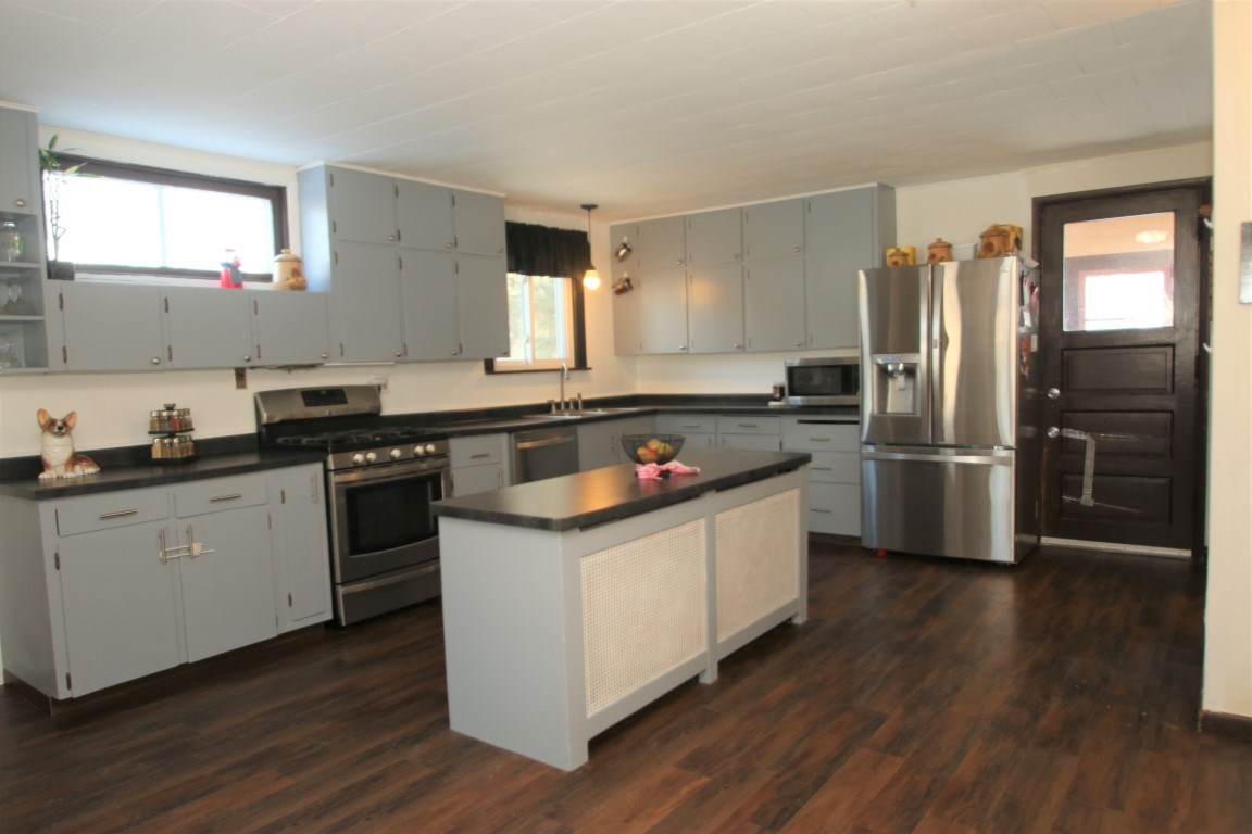 145 4th Street Capron, IL 61012 - Photo 12 of 24 a kitchen with a sink wooden floor and stainless steel appliances