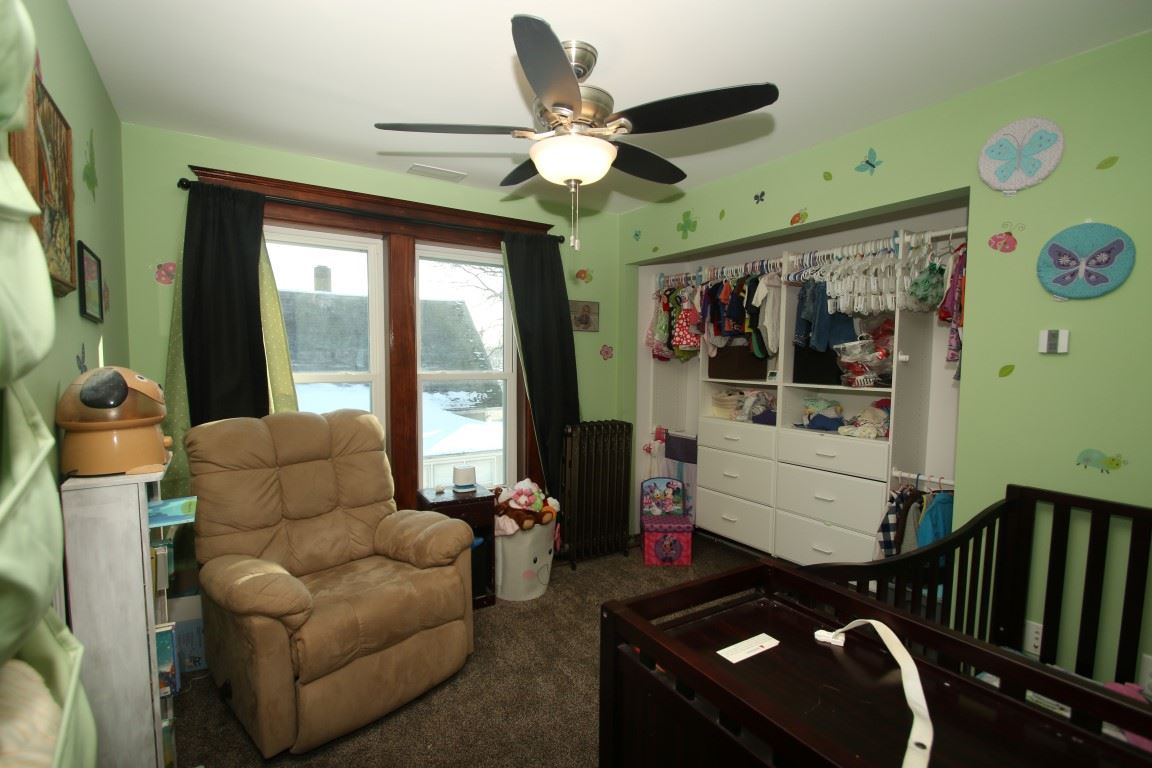 145 4th Street Capron, IL 61012 - Photo 18 of 24 a living room with furniture and a large window