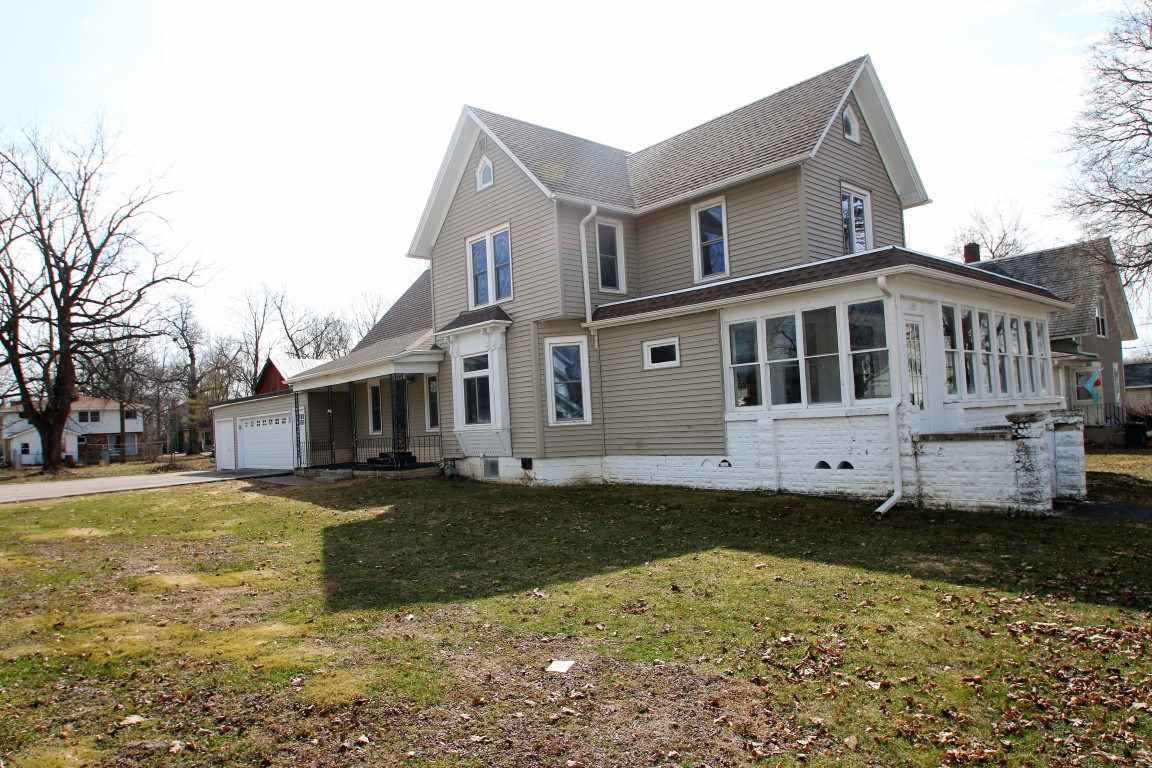 145 4th Street Capron, IL 61012 - Photo 2 of 24 a view of a white house with a big yard and large tree