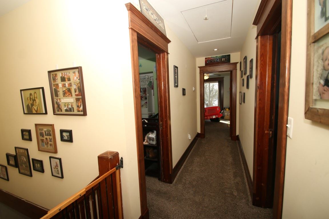 145 4th Street Capron, IL 61012 - Photo 21 of 24 a view of a hallway with paintings on the walls