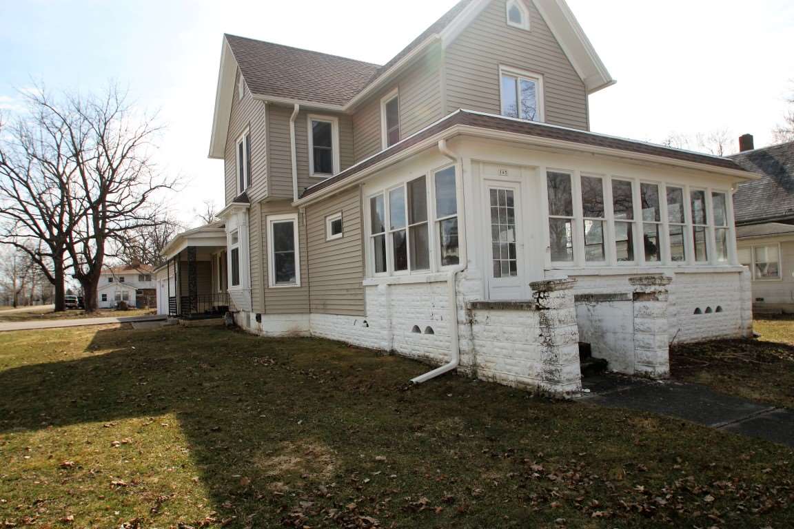 145 4th Street Capron, IL 61012 - Photo 3 of 24 a view of a large white building among the street