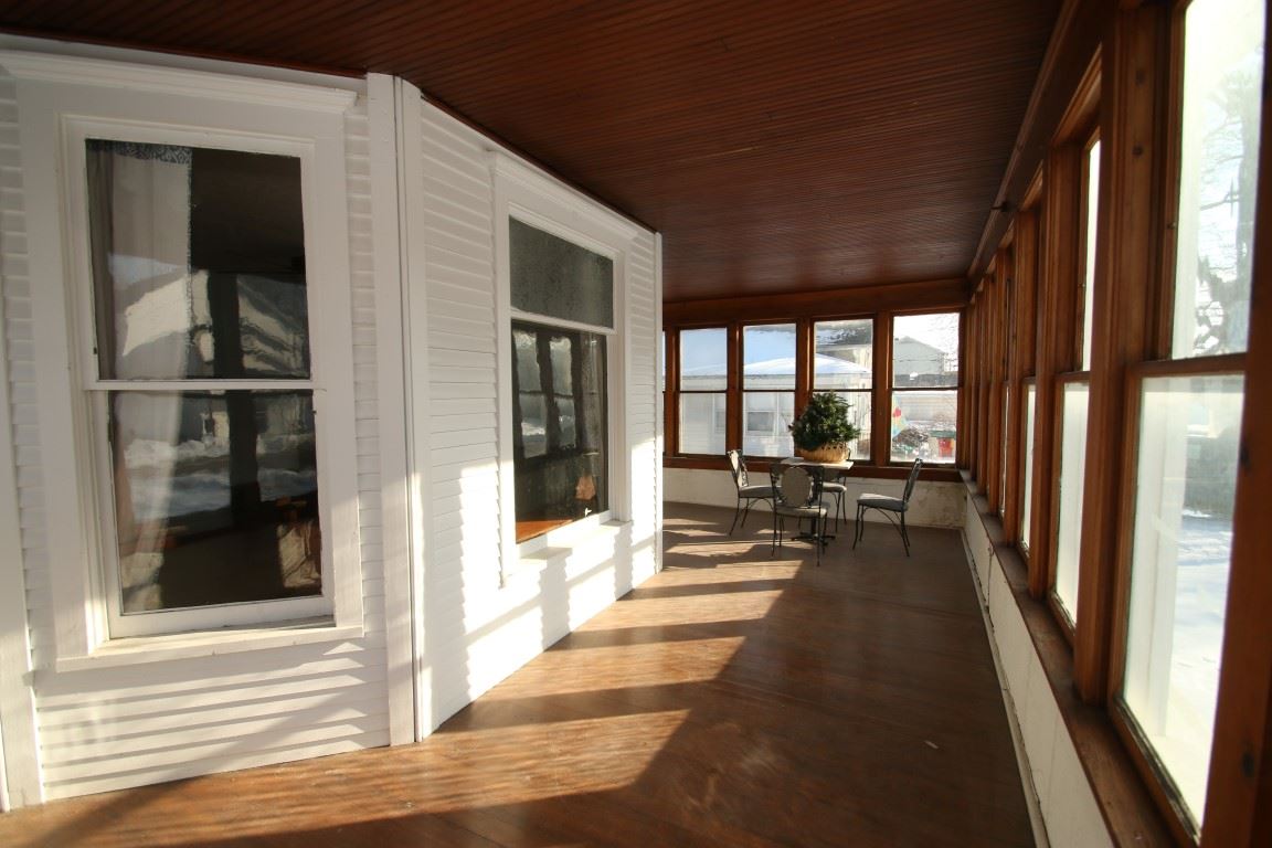 145 4th Street Capron, IL 61012 - Photo 6 of 24 a view of a balcony with chairs and floor to ceiling window
