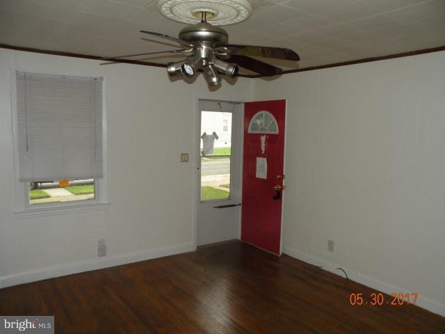 7616 Gum Road Baltimore, MD 21222 - Photo 3 of 5 a view of an entryway with wooden floor and a window
