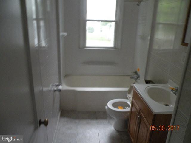 7616 Gum Road Baltimore, MD 21222 - Photo 5 of 5 a bathroom with a sink and a bathtub